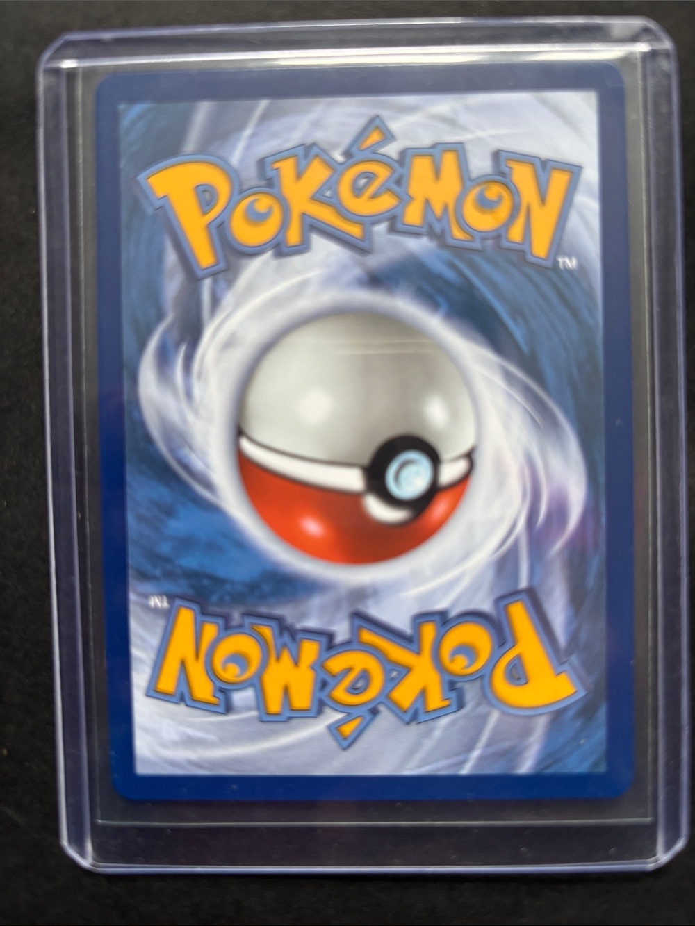 Pokemon Trading Card with Blue Back and Red Poké Ball